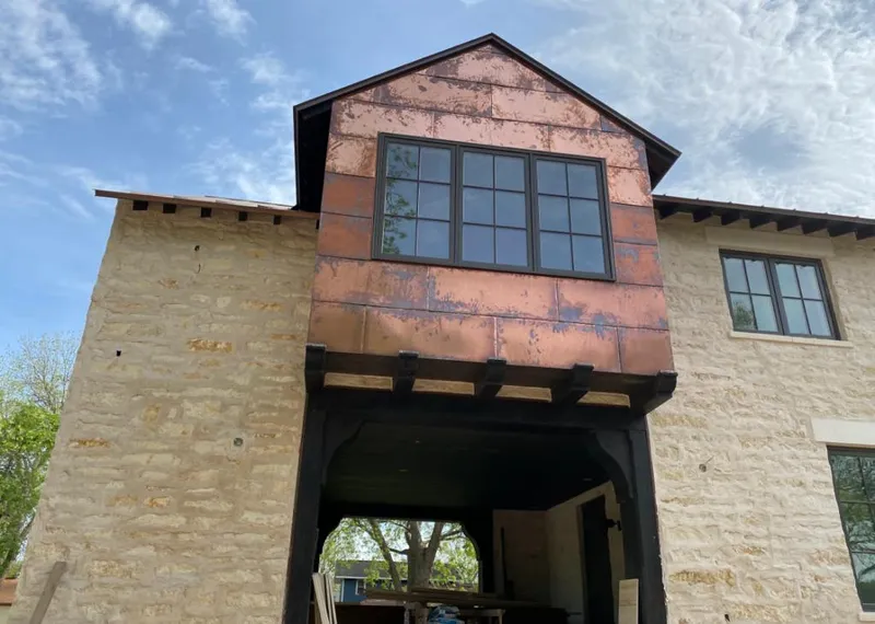 Copper metal panel facade on a stone building for Skylight Installation in Garner