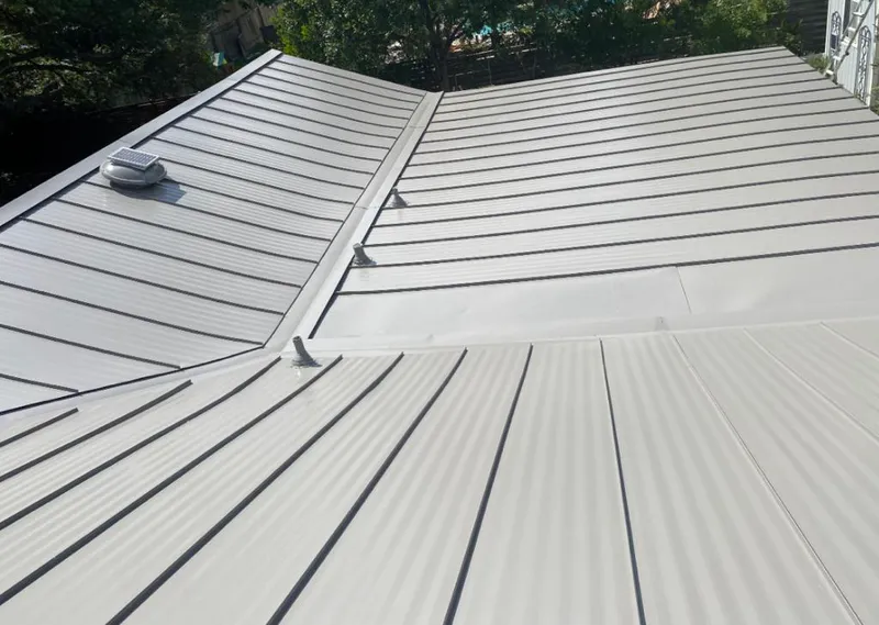 Solar attic fan installed on a metal roof for Roof Ventilation in Garner